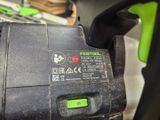 a close up of a black and green circular saw
