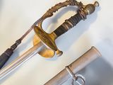 two swords that are laying on a white surface