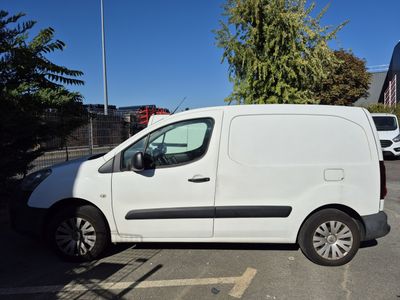 the white van is parked on the side of the road