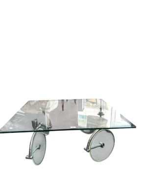 a glass coffee table with wheels and a glass top