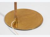 an image of a brass plate on a white surface with a cord