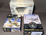 two boxed boxes of model aircraft collectibles sitting on a table