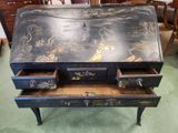 a black writing desk with two drawers on top of it