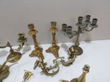 a lot of brass candlesticks on a white table