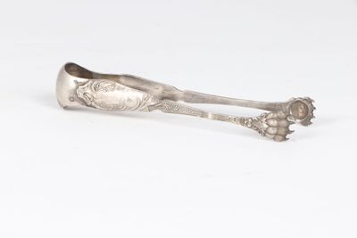 a silver spoon with a flower design on the handle