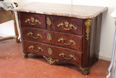 a marble top chest of drawers in the corner of a room