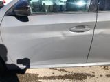 a car that has a broken door handle on the side of the road