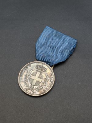 a close up of a medal with a blue ribbon on a black surface