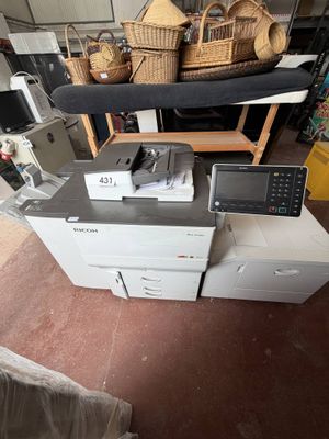 a pile of electronic equipment on a table in a room