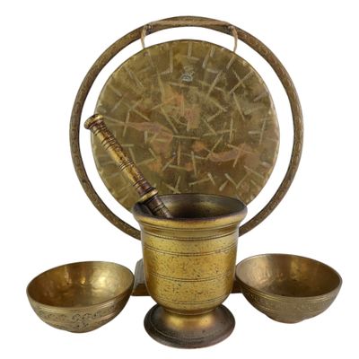 an image of a brass mortar set with three bowls and a wooden spoon