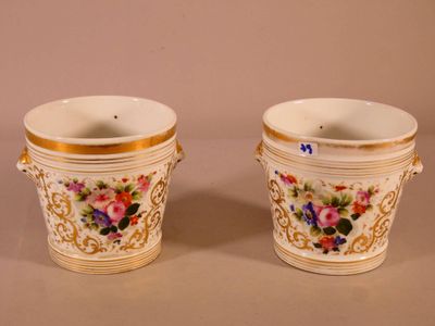 pair of porcelain vases with floral designs on them on a table
