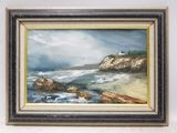 framed oil painting of a beach scene with a lighthouse in the distance