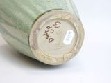 a close up of a green vase with writing on it
