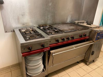 deux cuisinières dans la cuisine, sur lesquelles sont empilées des assiettes