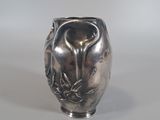 a silver vase that is sitting on a table