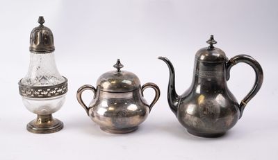 three silver teapots and a salt shaker on a white background