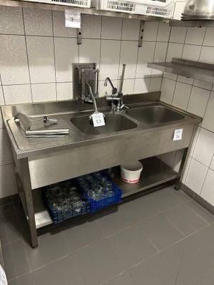 a kitchen with a sink and a lot of dishes