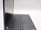a black laptop with a red button on the keyboard
