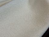 un gros plan d'une couverture blanche posée sur un lit