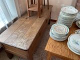 a wooden table with a bunch of plates on top of it