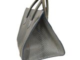 grey snake skin handbag on white background with blue trim