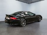 an image of a black sports car parked in a showroom