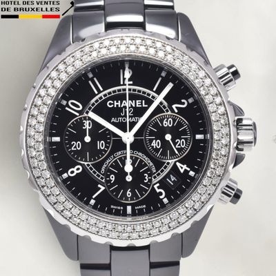 the watch is black and has a diamond bezeled bezel