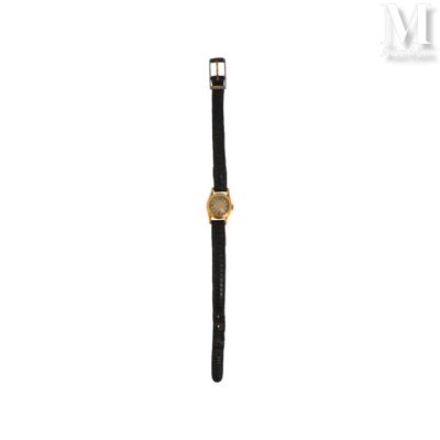 an image of a gold watch with a black leather strap