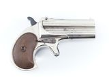 un revolver argenté à crosse en bois sur fond blanc