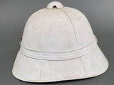 an old white helmet on a gray surface with a gray background