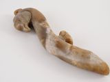 a long horn shaped object on a white surface