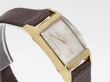 a close up of a wrist watch with a brown leather band
