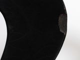 a close up view of a black vase with holes in it