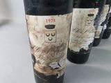 several bottles of wine are lined up on a table