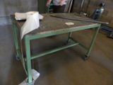 a man that is standing in front of a table
