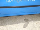 a blue car that has a magnet on the side of it