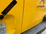 a close up of a yellow car with a sticker on it