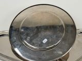 a silver plate sitting on top of a metal tray