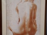 painting of a nude woman sitting on her back in a brown frame