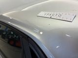 a sticker on the hood of a silver car