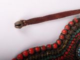 a close up of a necklace with beads on it