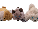 three stuffed animals sitting next to each other on a white surface
