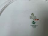 a white plate with a green and red design on it