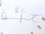 a picture of a clock with a handwritten word on it