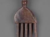 a wooden comb that is sitting on a table