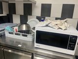 a microwave sitting on top of a counter in a kitchen