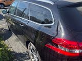 a black car parked in a parking lot next to a building