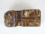 a small wooden object that is on a white surface