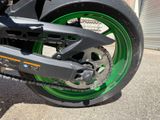 a close up of a motorcycle with green rims