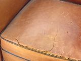 a piece of luggage sitting on the ground next to a chair